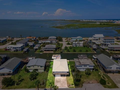 Enjoy the coastal charm of Anchor Down, a canal home in Sea Isle Subdivision, featuring an open-concept layout