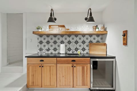 The hangout room’s bar is stocked with glasses and features a mini fridge for your convenience.