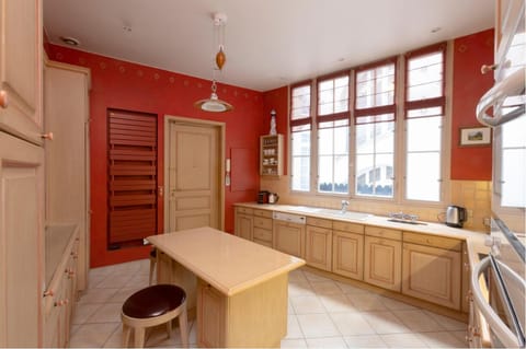Kitchen is traditionally laid out with blonde wooden cabinets,latest appliances