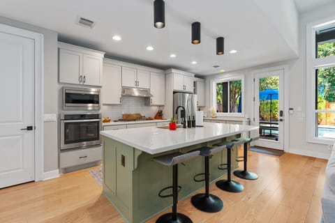 Cook up a gourmet meal in this fully equipped kitchen with stainless steel appliances, large island, and plenty of counter space. Ideal for large group meals or family dinners.