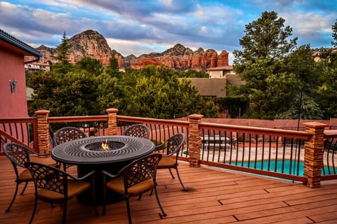 Living space deck with firepit overlooking pool and Thunder Mountain