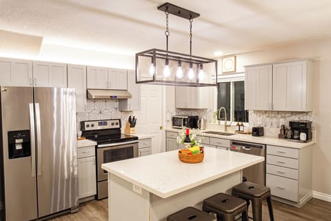 The fully equipped kitchen features all stainless steel appliances