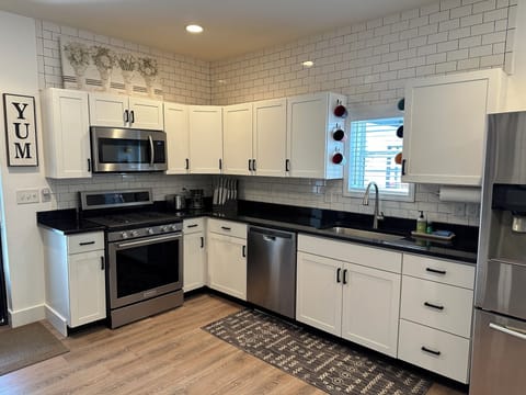 Fully stocked kitchen with stainless steel appliances.
