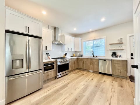 Stainless steel refrigerator, stove, oven, microwave, and dishwasher.
