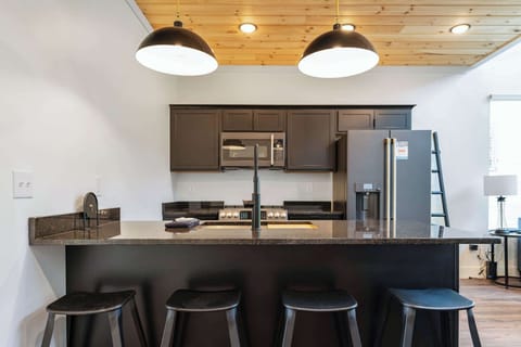 Entertain in style with sleek black cabinetry and stunning granite countertops!