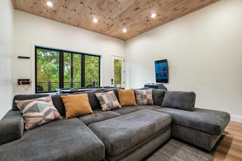 Sunlit space with a plush sectional, vibrant decor, and a homey vibe.