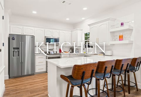 The spacious kitchen is both stylish and functional, offering everything you need to cook up a storm while staying connected with loved ones in the open-concept living area.