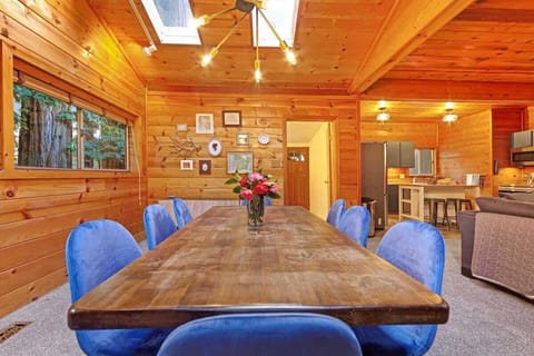 The dining area offers style and comfort with seating for six and redwood views.