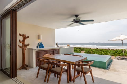 Dine al fresco with breathtaking ocean views from this private terrace, designed for relaxation and connection.