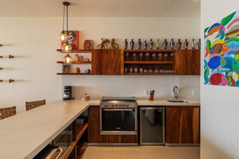 This sleek kitchen features high-end appliances, handcrafted cabinetry, and a beautiful mix of modern and rustic design elements.