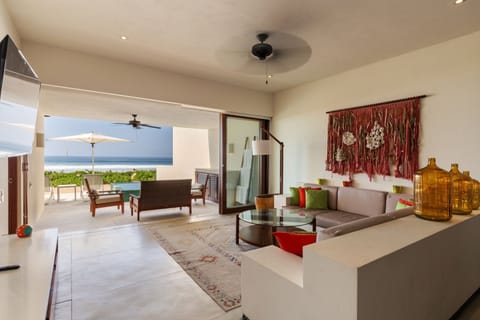 This beautifully designed living space features stylish decor, ample seating, and seamless access to the ocean breeze.