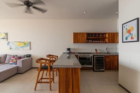 A fully equipped kitchen featuring high-end appliances, wooden cabinetry, and a spacious island for cooking and entertaining.