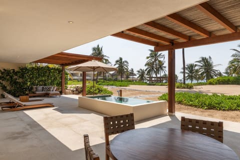 Enjoy a serene retreat by your private pool, surrounded by lush greenery and panoramic ocean vistas.