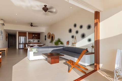 Cozy yet modern living space with ample seating, large windows, and tropical views for a refreshing stay.