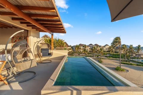 Enjoy panoramic views from your private rooftop terrace with a plunge pool and stylish hanging chairs—perfect for relaxing under the sun or stars.