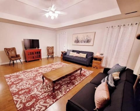 Spacious living room with smart TV, and 2 sofa beds