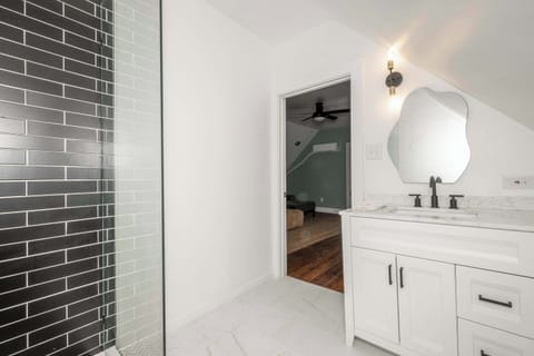 The final full bath features a single vanity & glass shower