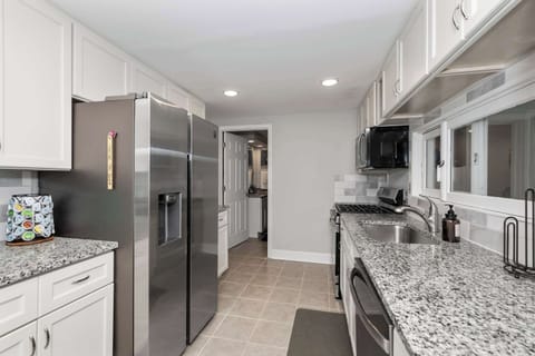 The bright, airy kitchen offers ample space & all the comforts of home