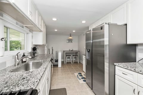 The bright, airy kitchen offers ample space & all the comforts of home