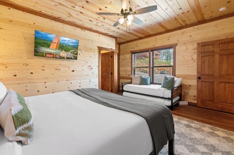 King bedroom with a twin trundle, TV, and full ensuite bathroom.