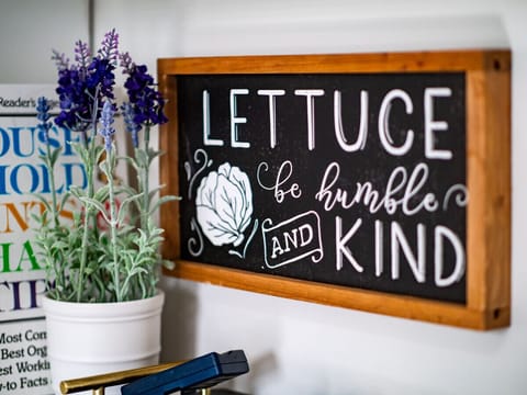 Playful kitchen décor adds warmth to this inviting space   - Fun wall art and potted greenery bring character indoors   - Personal touches create a welcoming stay experience