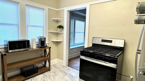 Fully equipped kitchen with refrigerator, stove, microwave and coffee maker.  