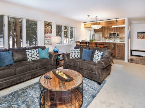 Bright living area with queen sofa sleeper, fireplace, balcony, and Smart TV