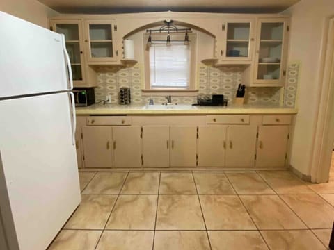 Fully stocked kitchen with original 1950s cabinets and aesthetics