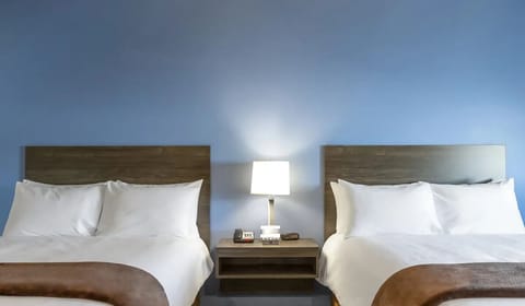 Drift off with cozy pillows, warm lighting, and quiet comfort.
