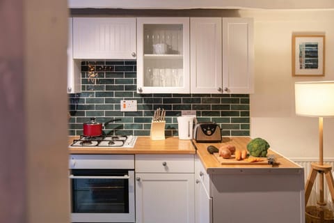 Kitchen with electric oven and wooden work surfaces