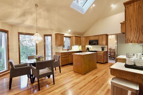 Open layout vaulted main floor w/ Kitchen, 2 Dining, & 2 Living spaces