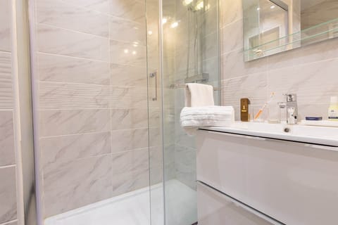The spacious and modern bathroom features stylish décor.