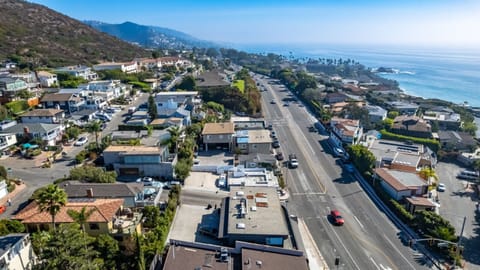 Aerial view of a coastal neighborhood, with stunning ocean views and easy beach access.