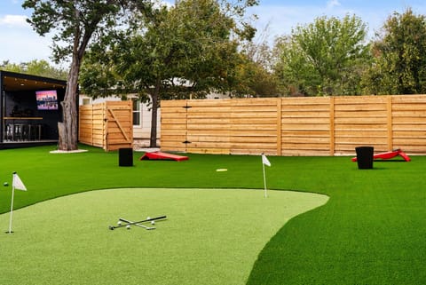 Putting green with putters and golf balls, bring your own wedge :) 