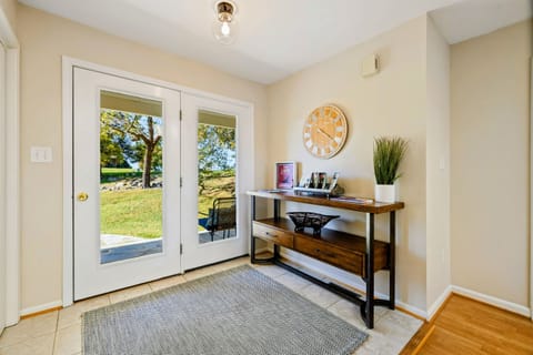 Bright and welcoming entryway with a view, featuring a stylish console table and decor