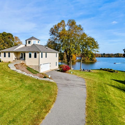 Charming lakefront home with a scenic driveway and easy water access for a perfect getaway