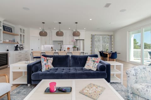 Plush navy velvet sofa alongside the stunning kitchen