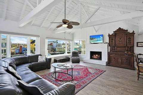 Modern spacious living area with TV and fireplace