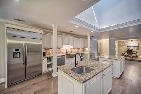 WOW! Look at all this space in the kitchen, complete with two island bars, a stainless-steel fridge with a water and ice dispenser, and a dishwasher, making it the perfect spot for cooking, entertaining, and everyday convenience!
