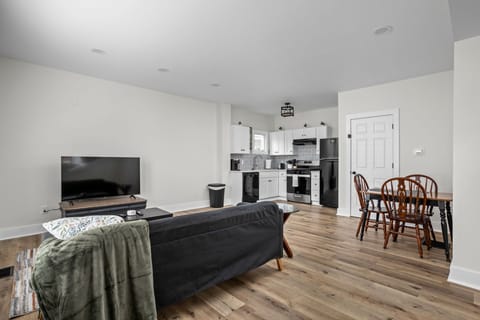 Living Room: Enjoy relaxing in a stylish space with a large TV, modern kitchen, and inviting dining nook!