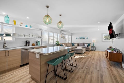 Welcome to your dream kitchen and living space, where modern design meets coastal charm.