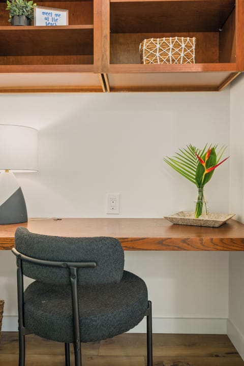 Master bedroom with ensuite bathroom, desk, walk-in closet and backyard access.