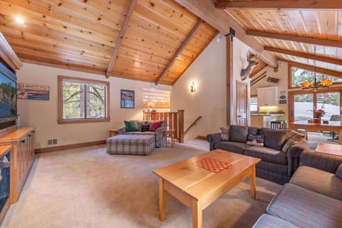 Lovely great room on main / upper floor with vaulted ceilings, fireplace and large flat screen TV.