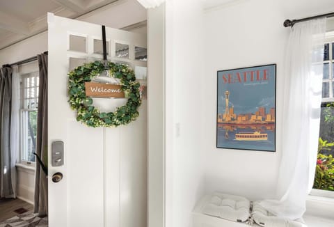 A warm welcome awaits you with a charming entryway adorned with a Seattle-themed art piece.