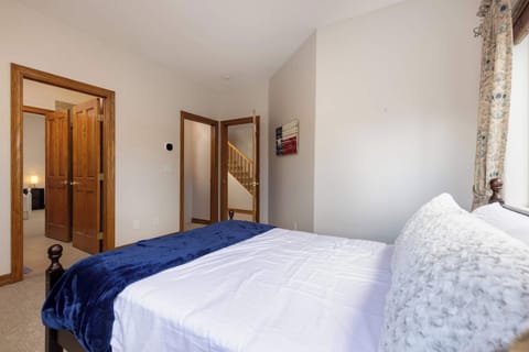 Mid-level private bedroom 2 with queen bed. Bathroom is jack-and-jill style that connects to the other bedroom