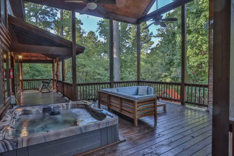 Relax in the hot tub or lounge under the covered deck, surrounded by lush forest views.