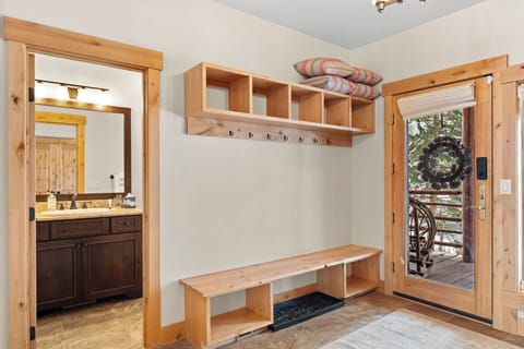 Unit entryway with storage space and guest bathroom.