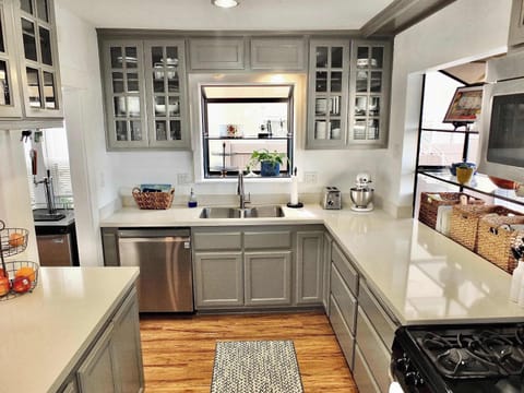 The airy kitchen offers ample space & all the comforts of home