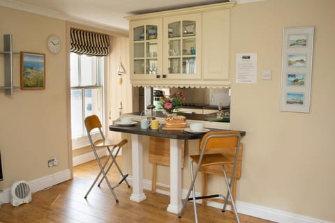 Breakfast bar laid for tea with two bar stools