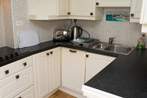 Wall and base cupboards. Fully tiled walls